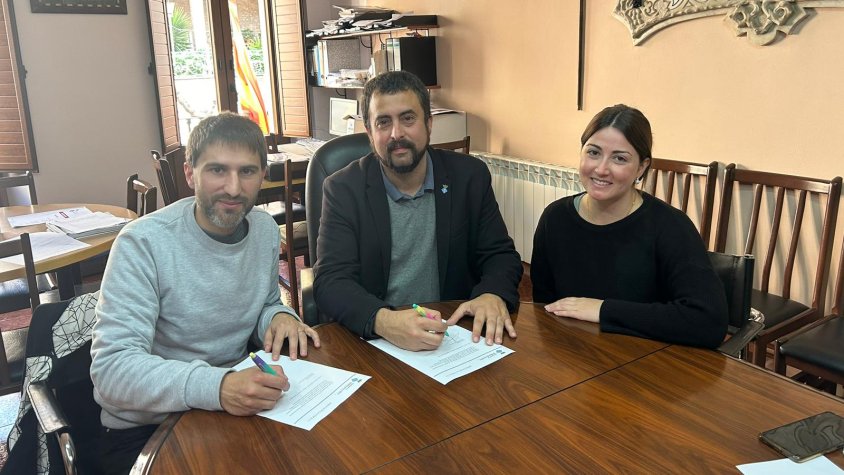 Les dues parts signant el conveni